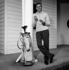 Mid adult man leaning against column with golf trolley beside Poster Print - Item # VARSAL255417152