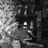 Woman reading card under Christmas tree Poster Print - Item # VARSAL255418106