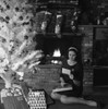 Woman reading card under Christmas tree Poster Print - Item # VARSAL255418106