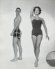 Young man looking at a young woman walking in swimsuit Poster Print - Item # VARSAL25526833