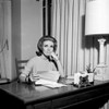 Sad young woman sitting at desk  holding letter Poster Print - Item # VARSAL255417754