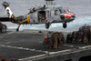 A Sailor hooks cargo to an MH-60S Sea Hawk helicopter Poster Print - Item # VARPSTSTK104973M