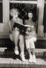 Two young women looking at photo album Poster Print - Item # VARSAL1073103