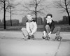 Two boys with roller skates sitting on curb Poster Print