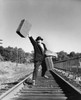 Mid adult man running with luggage on a railroad track Poster Print - Item # VARSAL25525186