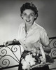 Portrait of a young woman holding a basket of flowers Poster Print - Item # VARSAL25541759