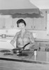Young woman cooking in kitchen Poster Print - Item # VARSAL255419207