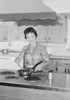 Young woman cooking in kitchen Poster Print - Item # VARSAL255419207