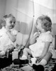 Baby girl applying cosmetics in front of mirror Poster Print - Item # VARSAL2552018