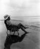 Woman relaxing on chair on beach Poster Print - Item # VARSAL25548962