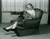 young woman sitting in armchair  reading magazine Poster Print - Item # VARSAL255417244