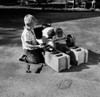 Boy repairing gocart in playground Poster Print - Item # VARSAL255424914