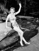 Young woman wearing bikini waving Poster Print - Item # VARSAL255424526