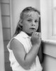 Little girl standing near window with hands folded Poster Print - Item # VARSAL25514371