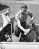 Mid adult man cleaning his car seat with a rag Poster Print - Item # VARSAL2557901
