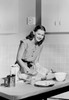 Young woman preparing cake in domestic kitchen Poster Print - Item # VARSAL255422349A