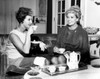 Two women drinking tea and talking in living room Poster Print - Item # VARSAL25528880