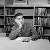 School boy reading in library Poster Print