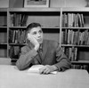 School boy reading in library Poster Print