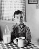 Boy sitting at the table and drinking milk Poster Print - Item # VARSAL2555742