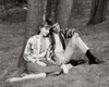 Teenage couple sitting in park listening to radio Poster Print - Item # VARSAL2557550