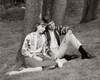Teenage couple sitting in park listening to radio Poster Print - Item # VARSAL2557550