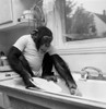 Chimpanzee washing a plate in a kitchen sink Poster Print - Item # VARSAL9901552