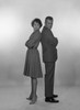Mid adult couple looking black at each other  studio shot Poster Print - Item # VARSAL255417381B