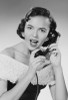 Studio portrait of young woman talking on phone Poster Print - Item # VARSAL255422846