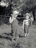 Two boys with bunch of fish and fishing rod made of stick in field Poster Print - Item # VARSAL2556629