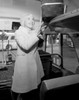 Woman putting luggage in bus Poster Print - Item # VARSAL255416285