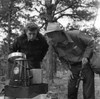 Couple cooking outdoors  man holding fishing rod Poster Print - Item # VARSAL255421143