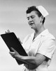 Female nurse writing on a clipboard Poster Print - Item # VARSAL25534564
