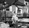 Girl putting food into birdhouse Poster Print - Item # VARSAL255416404