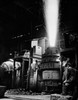 Rear view of a mature man looking at a Bessemer converter in a steel mill Poster Print - Item # VARSAL2555492