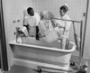 Two healthcare workers helping a patient bathe Poster Print - Item # VARSAL25526324