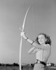 Young woman shooting with bow Poster Print - Item # VARSAL255422355
