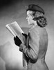 Side profile of a young woman reading a newspaper Poster Print - Item # VARSAL25528056