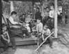 Teacher sitting with his students on a porch and reading a book Poster Print - Item # VARSAL25516621