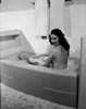 Young woman taking bath Poster Print