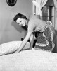 Side profile of a young woman preparing a bed Poster Print - Item # VARSAL255398