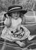 Baby girl sitting on blanket  smiling and wearing hat Poster Print - Item # VARSAL990359107