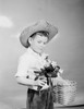 Boy holding bunch of flowers in one hand and basket in another Poster Print - Item # VARSAL255424319