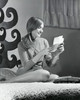 Teenage girl sitting on the bed and reading a letter  1968 Poster Print - Item # VARSAL255910A