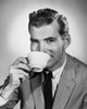 Portrait of a mid adult man drinking from a tea cup Poster Print - Item # VARSAL25512620