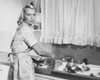 Portrait of a young woman washing pots and pans in a kitchen Poster Print - Item # VARSAL25541819