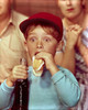 Close-up of a boy eating a hot dog and holding a bottle of soda Poster Print - Item # VARSAL3811361955