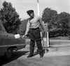 Man filling gas tank in car with patrol Poster Print - Item # VARSAL255416393