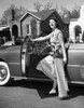 Young woman opening the door of a car Poster Print - Item # VARSAL2554647