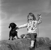 Girl with dog sitting on rock Poster Print - Item # VARSAL25514233